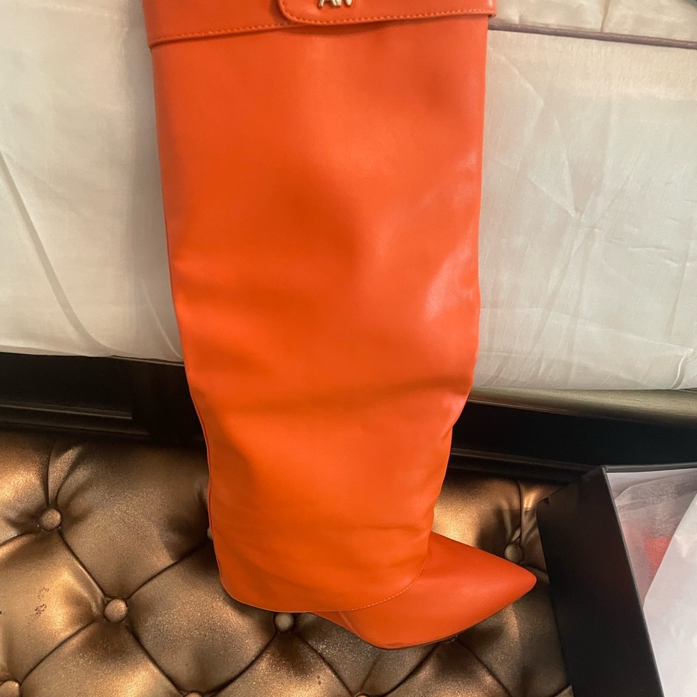 Orange Boots says size 7.5 women but run narrow and small.